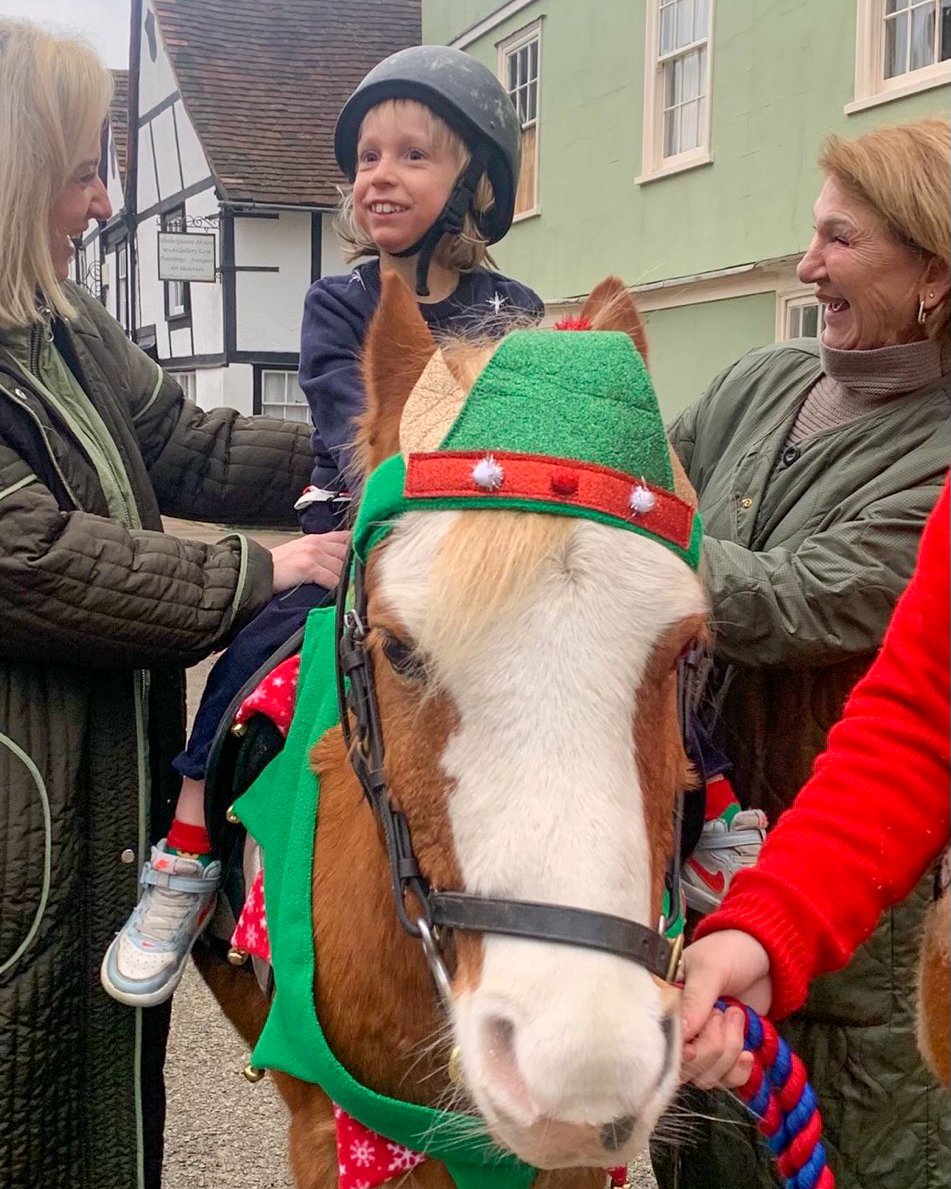 Photo of young client on horseback wearing a festive outfit