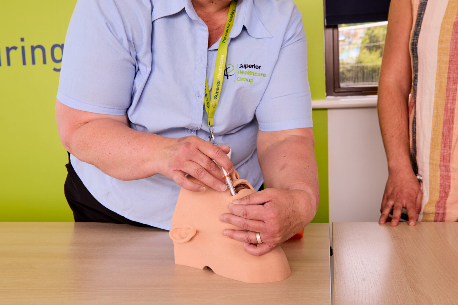 Image of one of our trainers on the Epilepsy Awareness with Rescue Medication Administration training course demonstrating medication administration on a dummy.