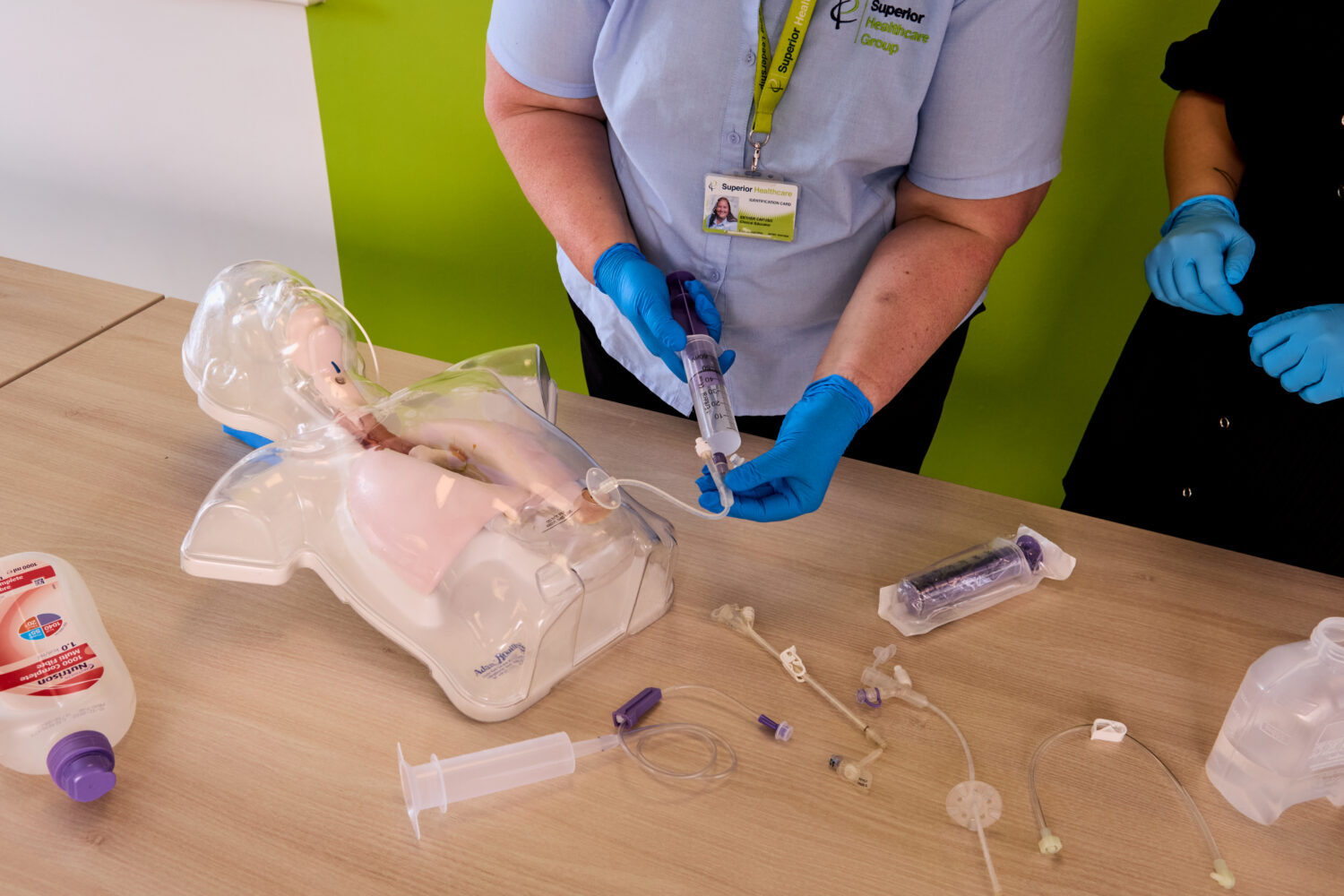 Image of one of our trainers on the Enteral Feeding training course demonstrating medical equipment.