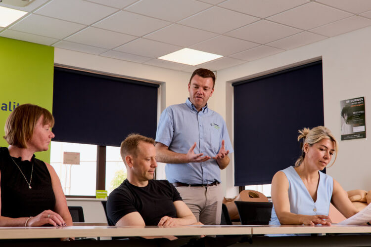 Image of a trainer on The Care Certificate training course engaging with attendees.