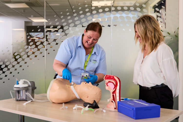 Image of one of our trainers on the Adult and Paediatric Tracheostomy Awareness training course demonstrating tracheotomy on a dummy to an attendee.