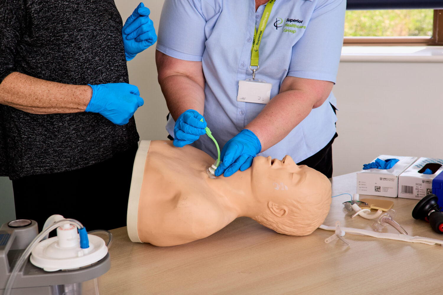 Image of one of our trainers on the Adult and Paediatric Tracheostomy Awareness training course demonstrating on a dummy.