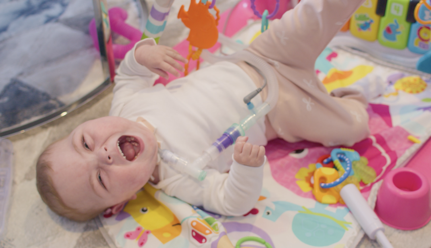 baby laughing on a playmat
