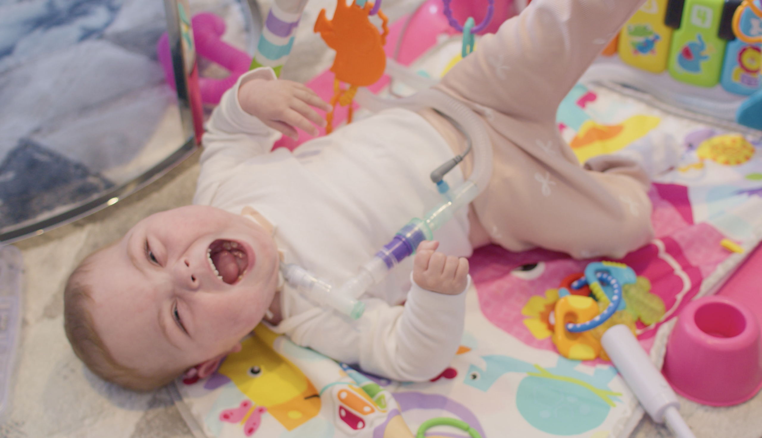 baby laughing on a playmat