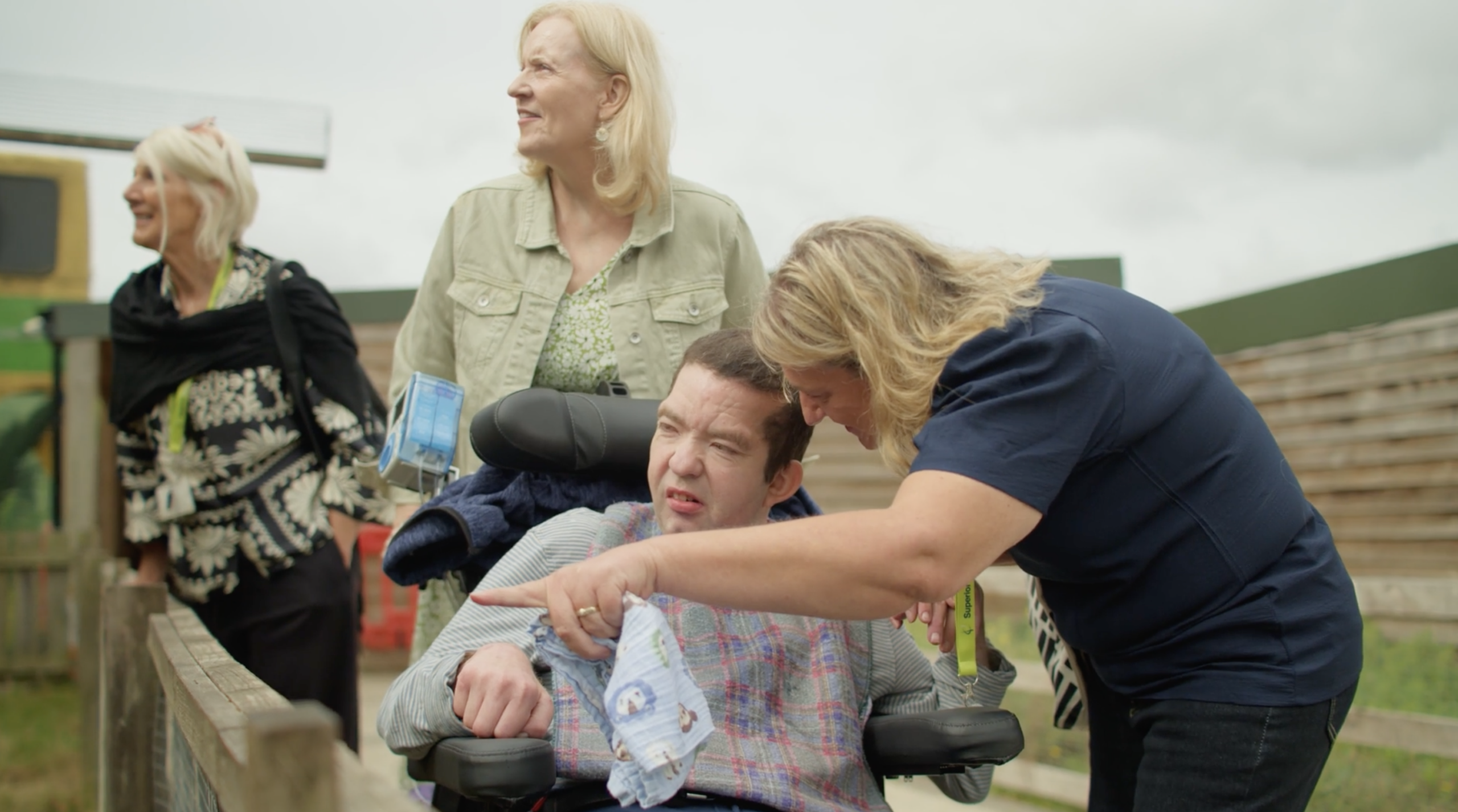 Man with complex care smiling with his carer